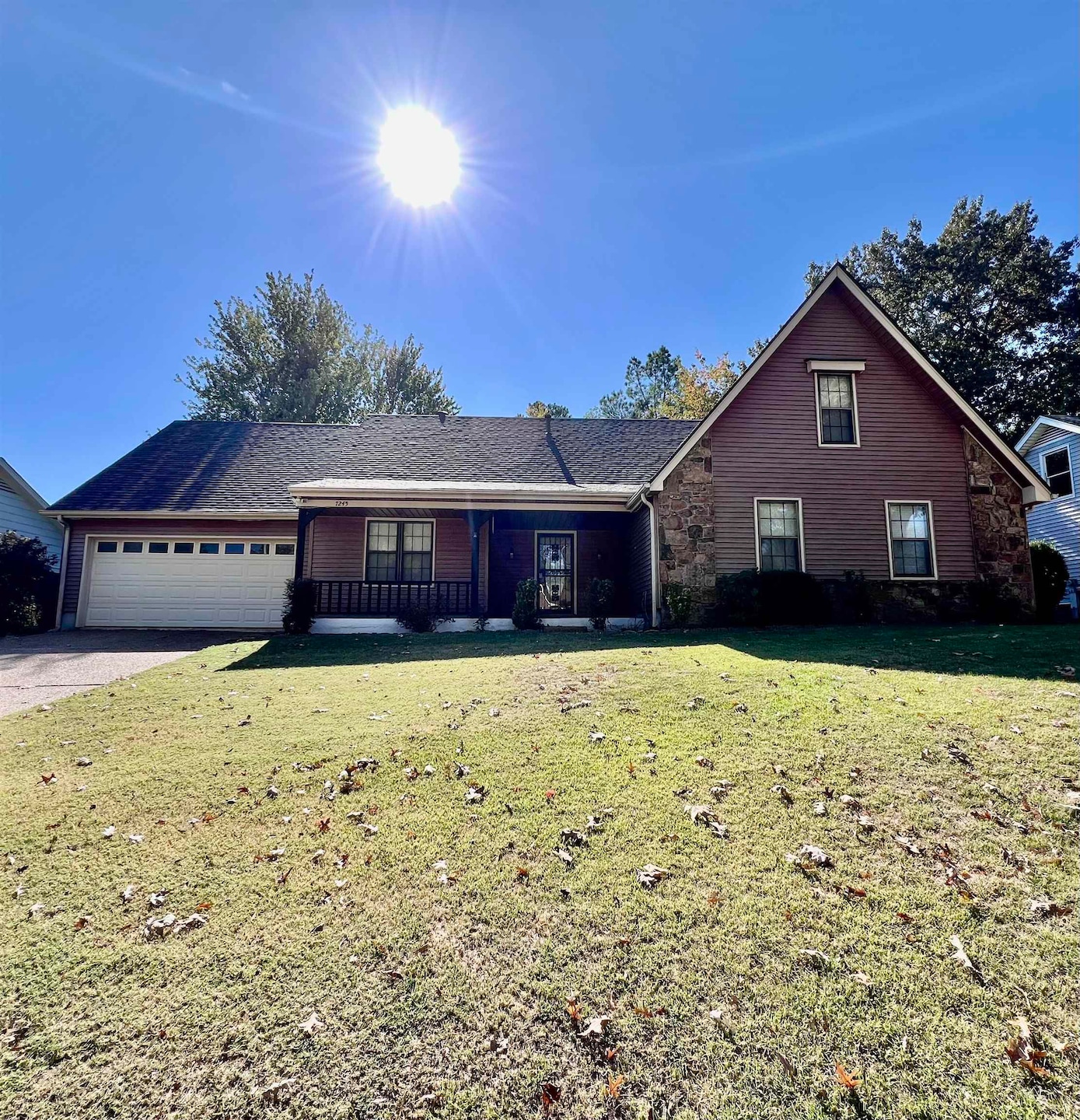 Front facade featuring a front lawn and a garage