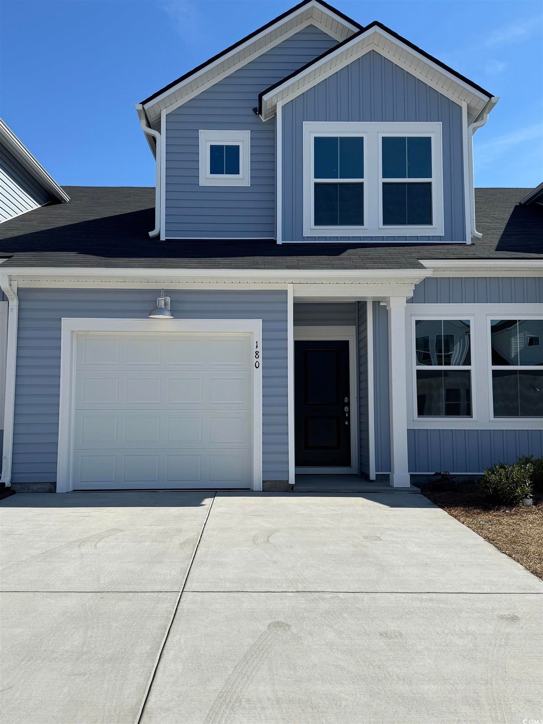View of front of home with a garage, concrete driv