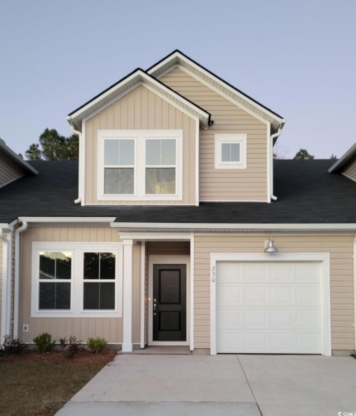 View of front facade featuring a garage