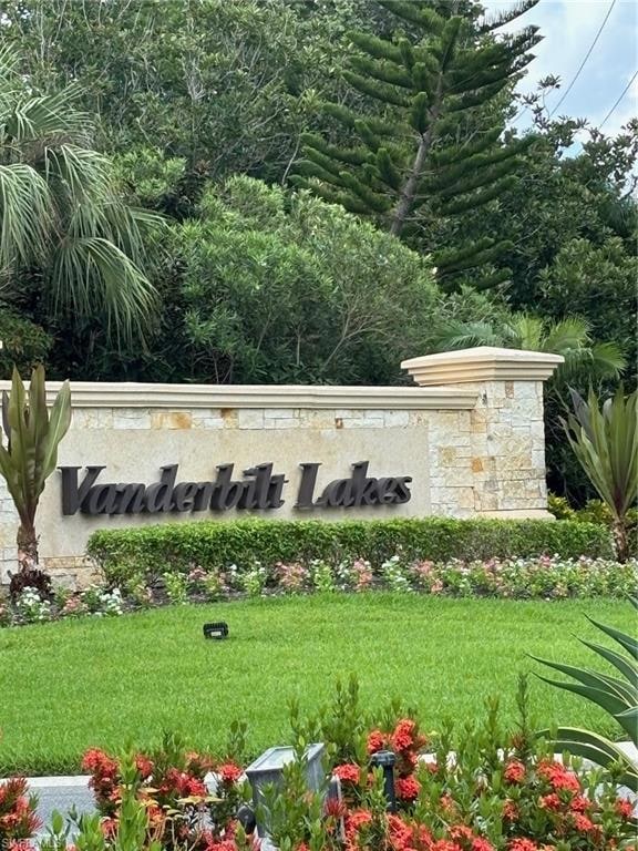 Community / neighborhood sign with a yard
