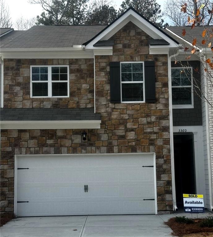 View of front facade featuring a garage