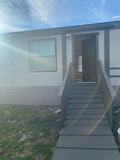 Unfurnished living room featuring dark wood-type flooring and ceiling fan