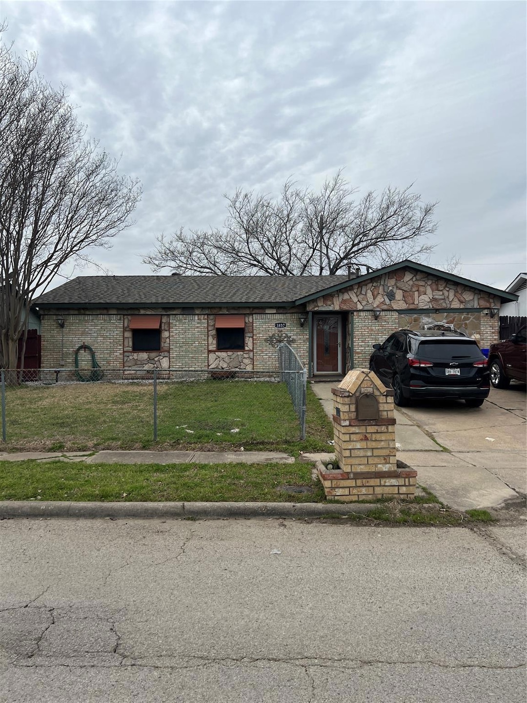 View of front of home with a fenced front yard, a 