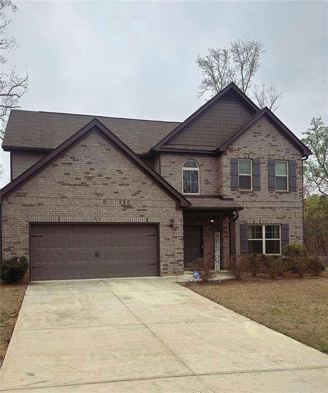 View of front facade featuring brick siding, concr