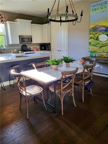 White cabinets. quartz countertops, dining with co