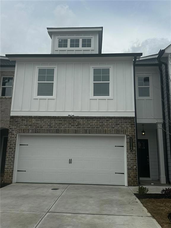 View of front facade featuring a garage