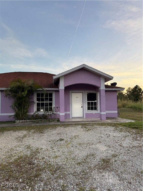 View of front facade with a porch and stucco siding
