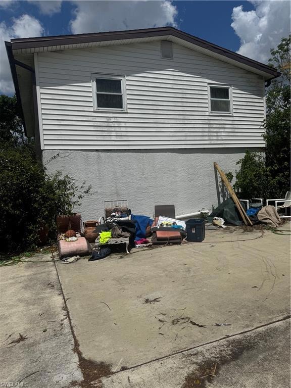 View of side of home with stucco siding