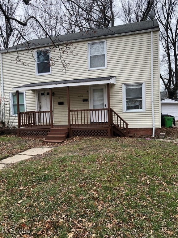 View of front of home featuring a front yard and covered porch