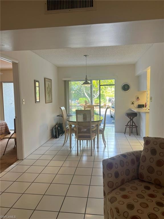 Dining room featuring light tile patterned floors 