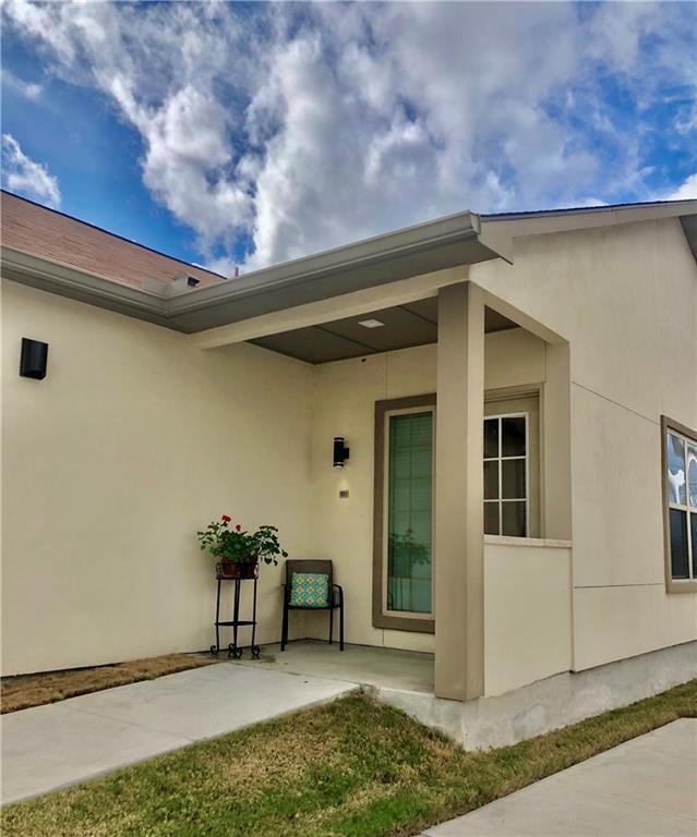 View of exterior entry with stucco siding