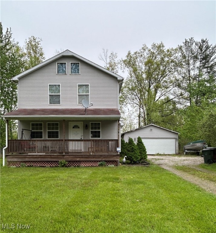 View of front of house with a detached garage, covered porch, an outdoor structure, and a front lawn