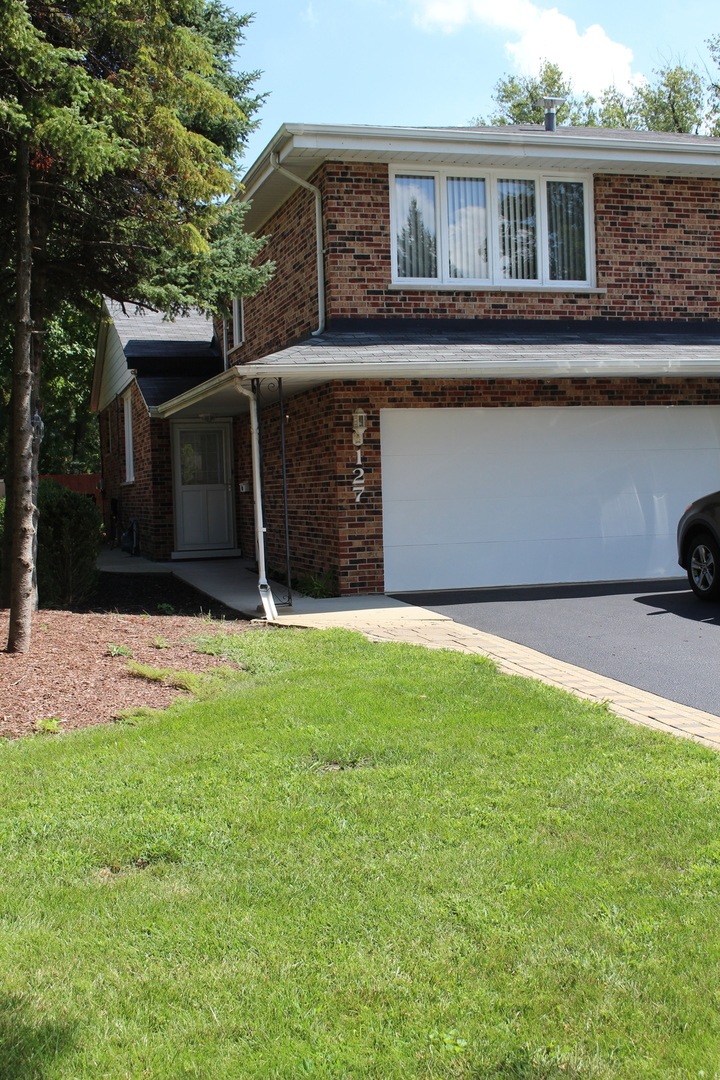 Well maintained yard with mature trees.