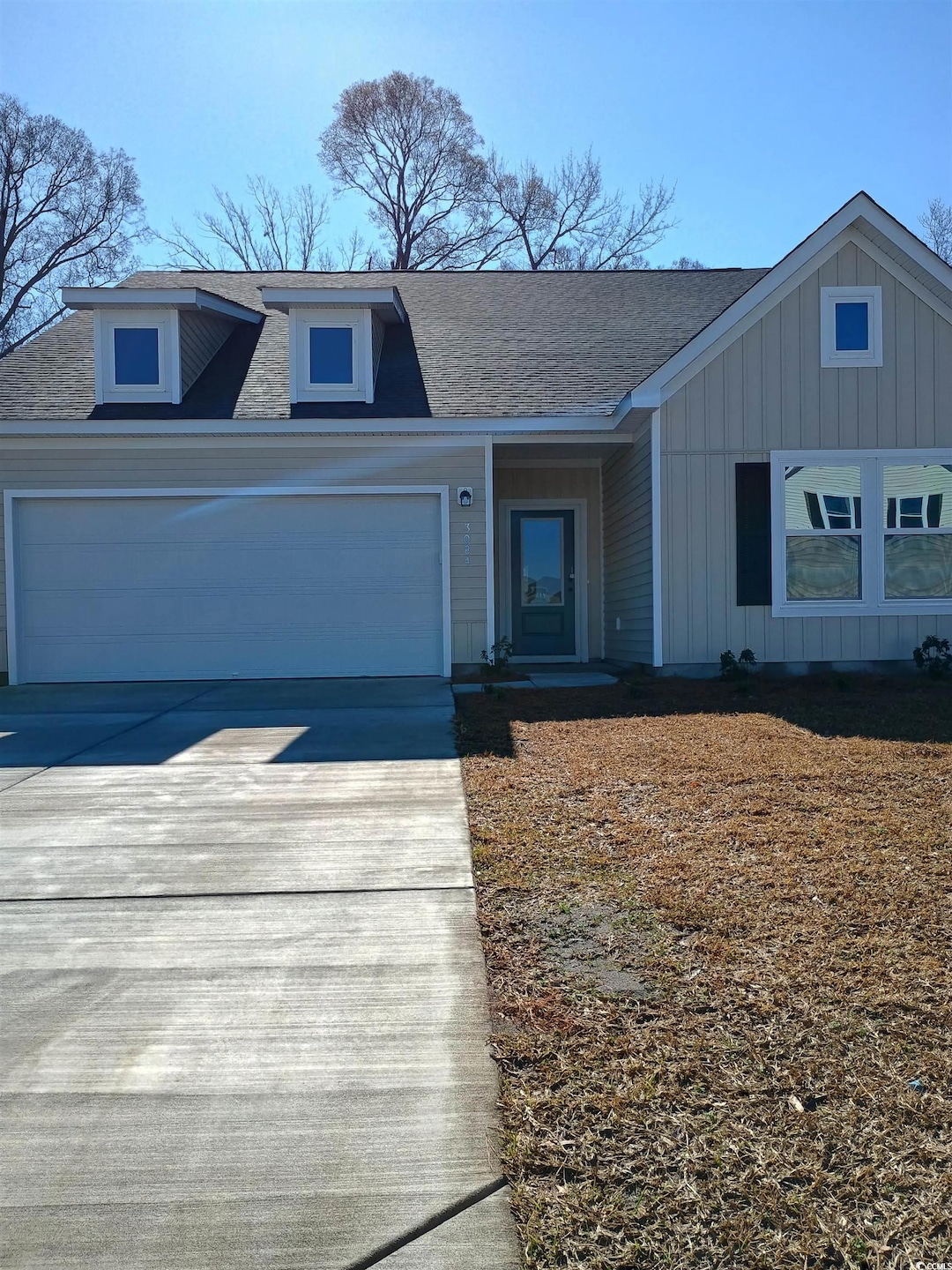View of front of property featuring driveway, an a