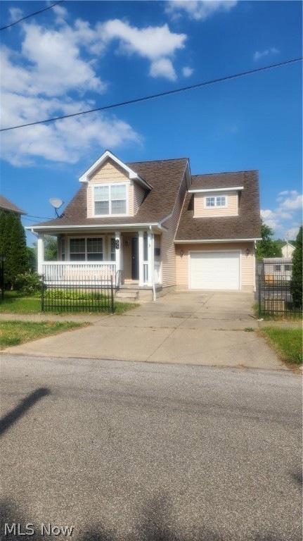 View of front facade featuring a garage and a porch