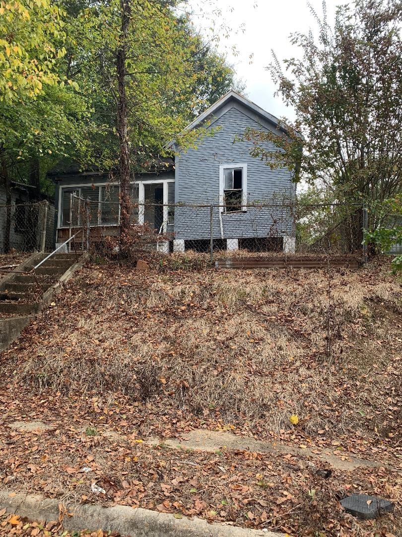 View of side of property featuring a sunroom