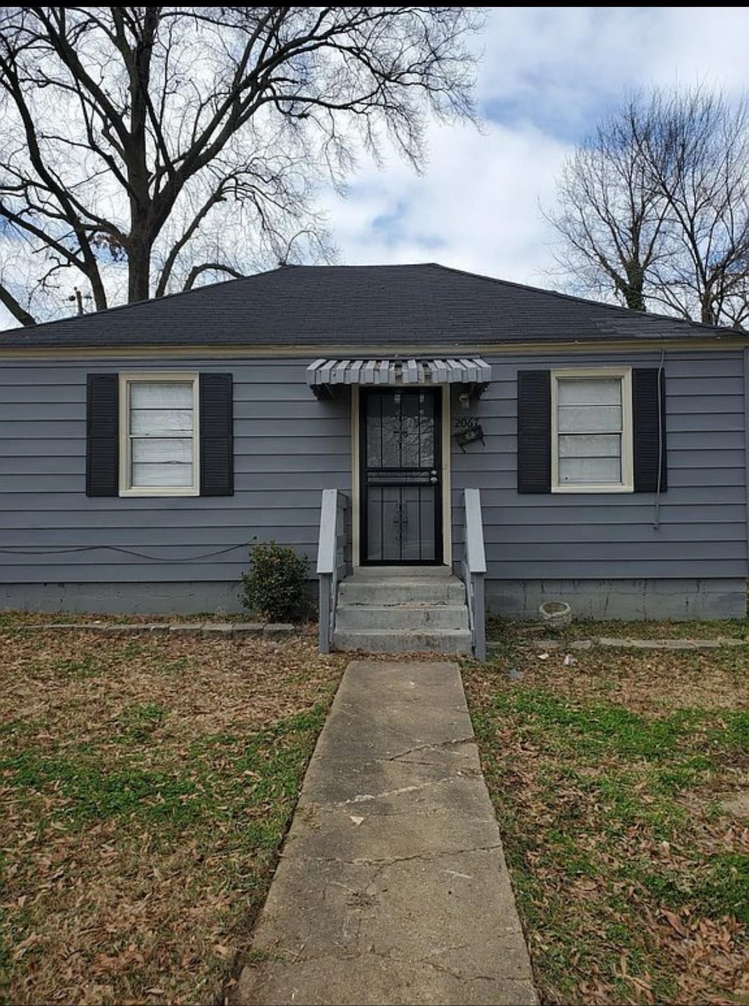 View of front of home with a shingled roof