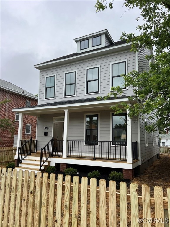 View of front of house with covered porch and a fe