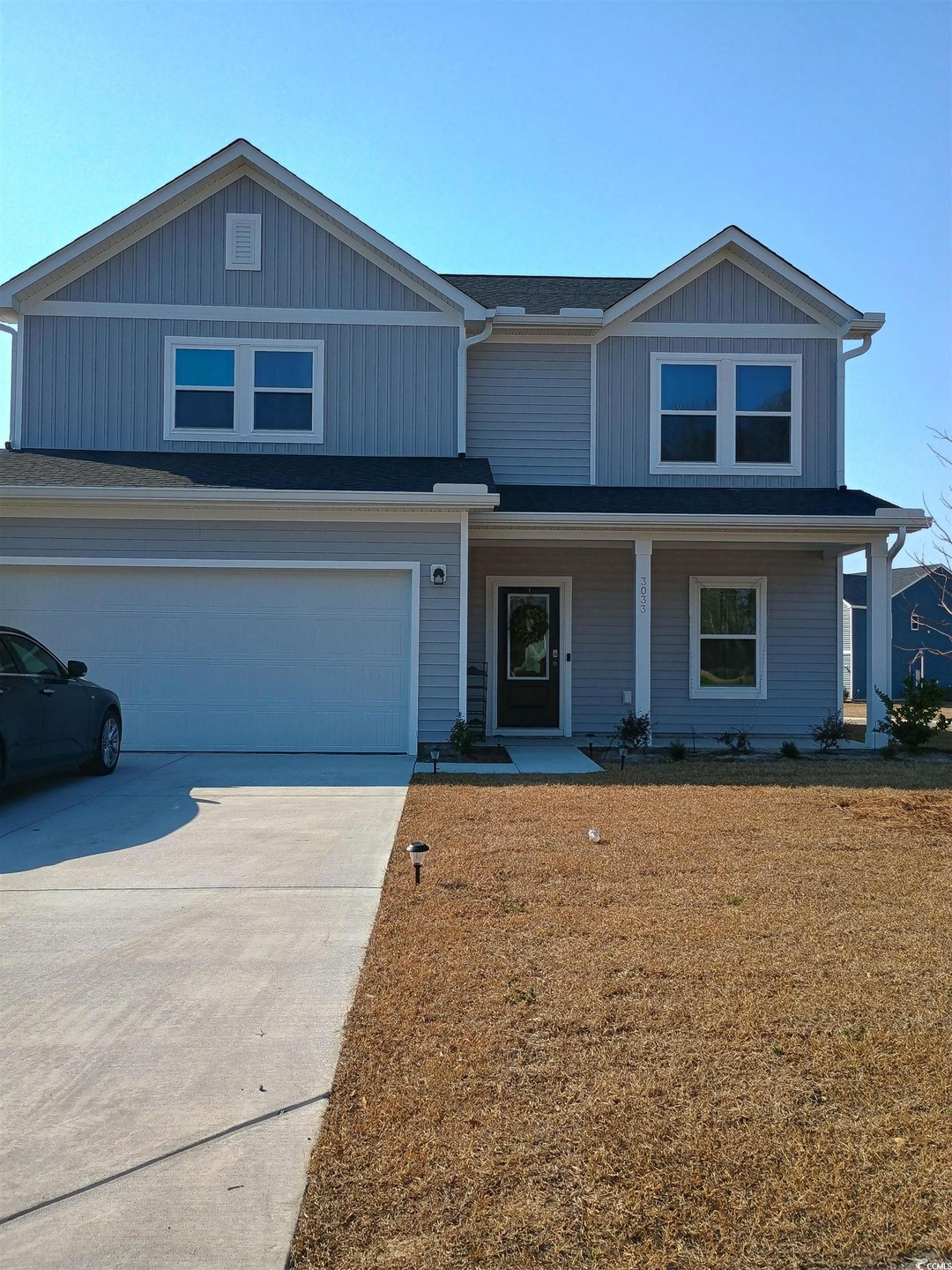 View of front of home featuring a garage, concrete