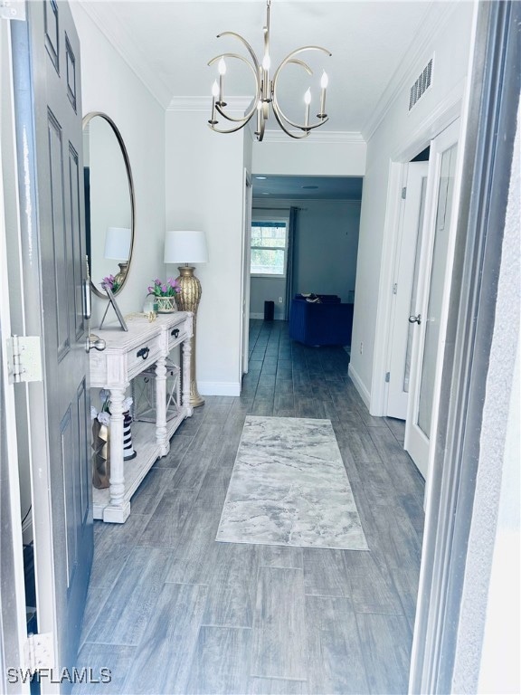 Hallway with ornamental molding, dark wood-type fl
