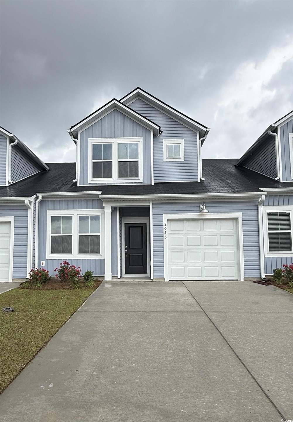 View of front of property with a shingled roof and