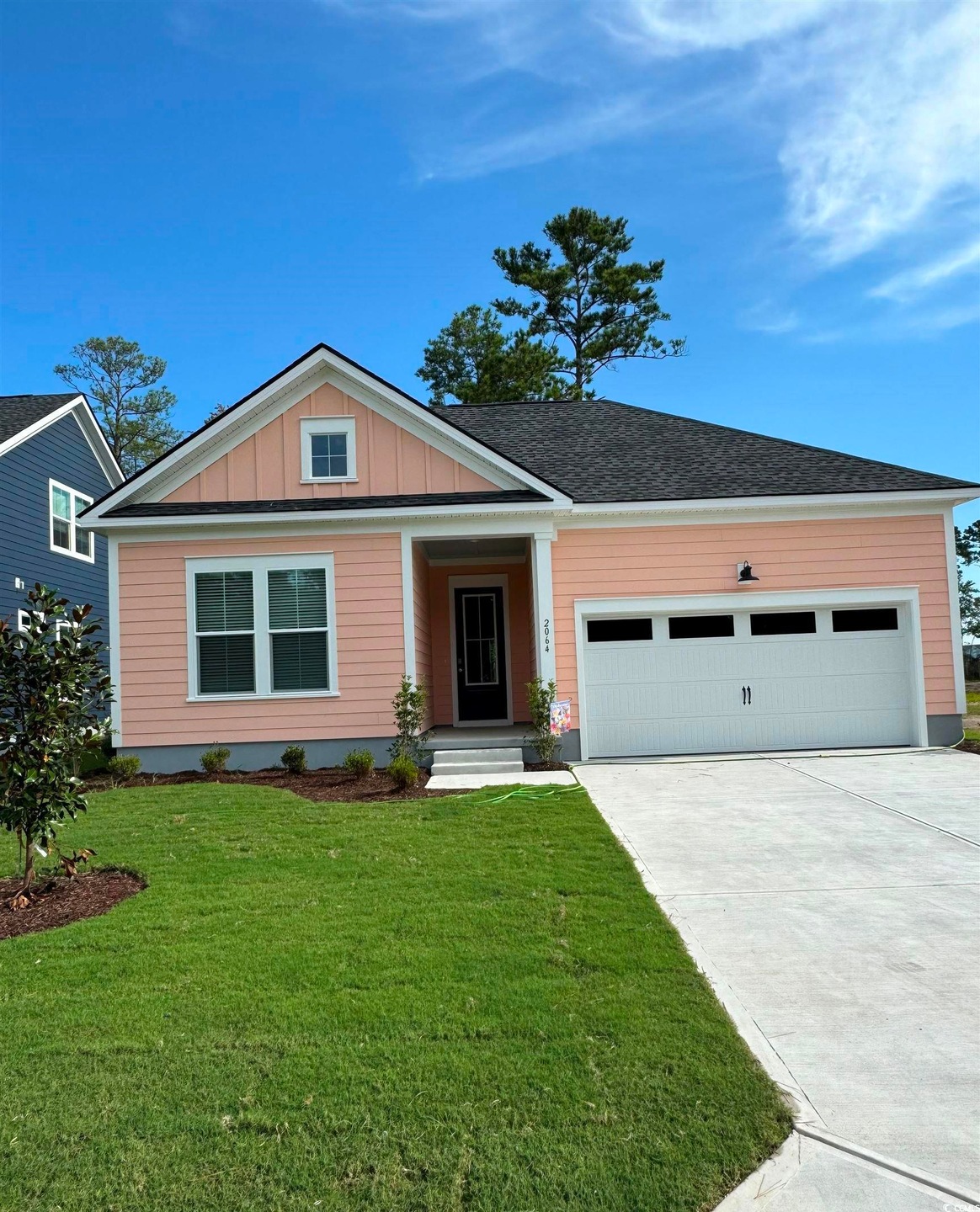 View of front facade with a front yard and a garage