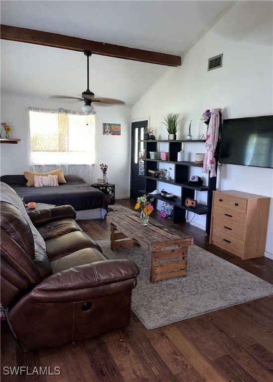 Living room featuring ceiling fan, dark hardwood /