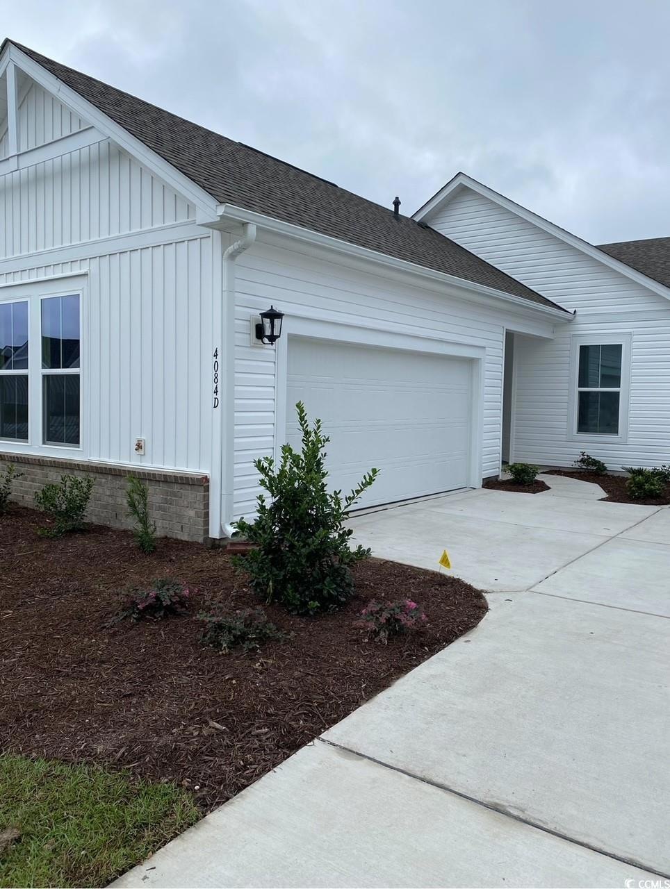 View of side of home with a garage
