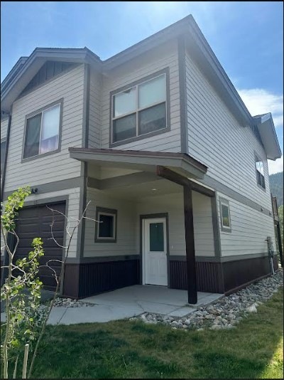 Rear view of house with a porch and a garage