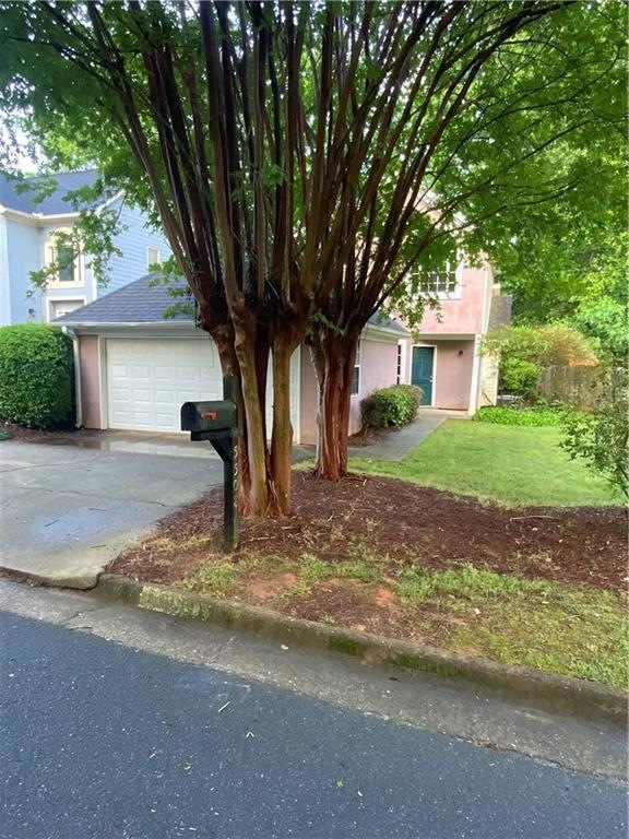 Obstructed view of property with concrete driveway