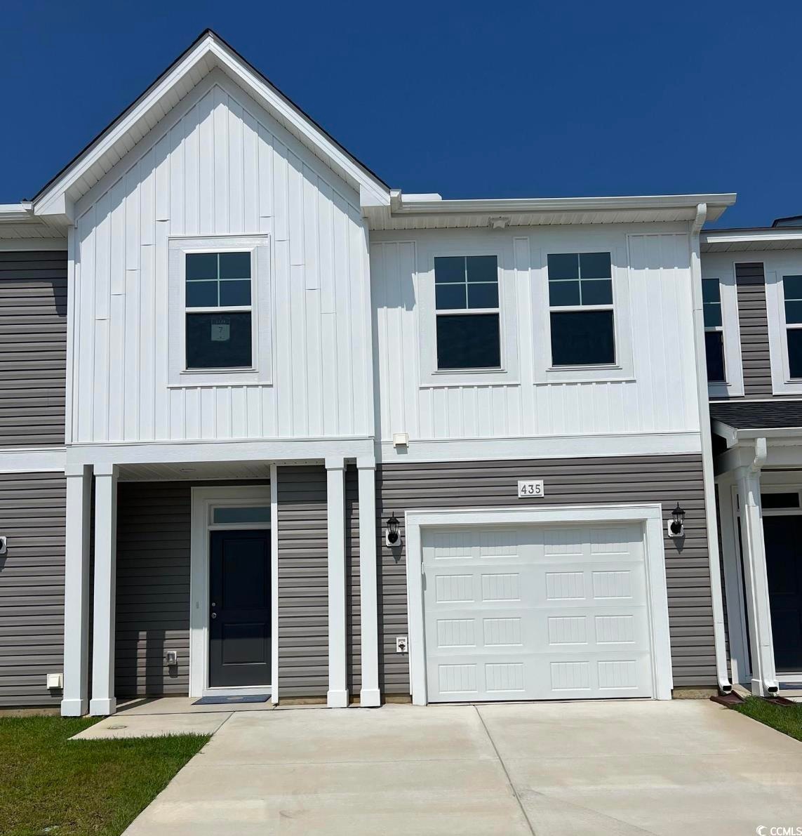 View of front of property with a garage, driveway,