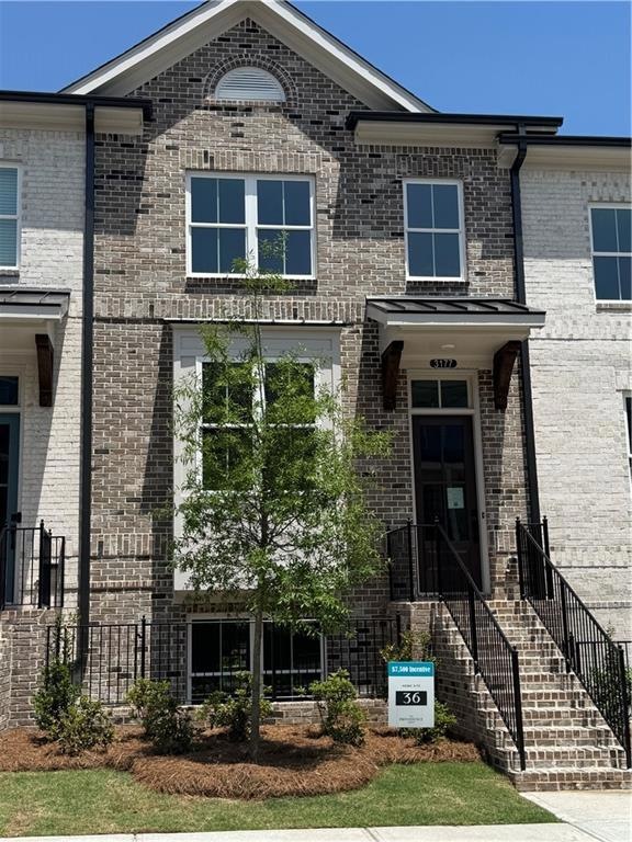 View of front of house featuring brick siding