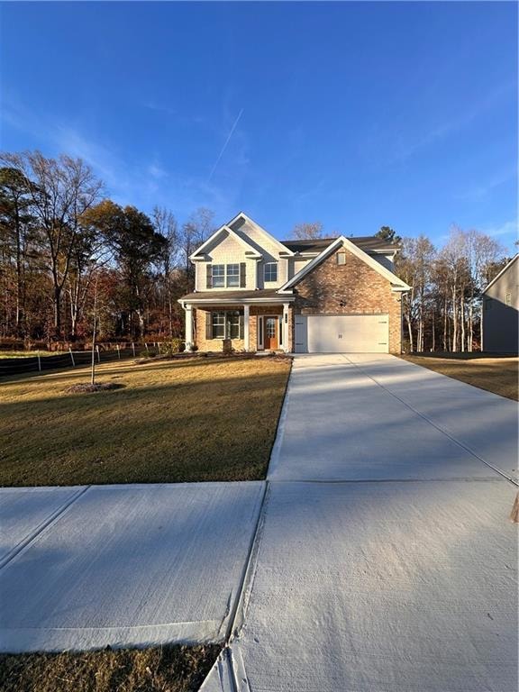 View of front of house with concrete driveway, bri