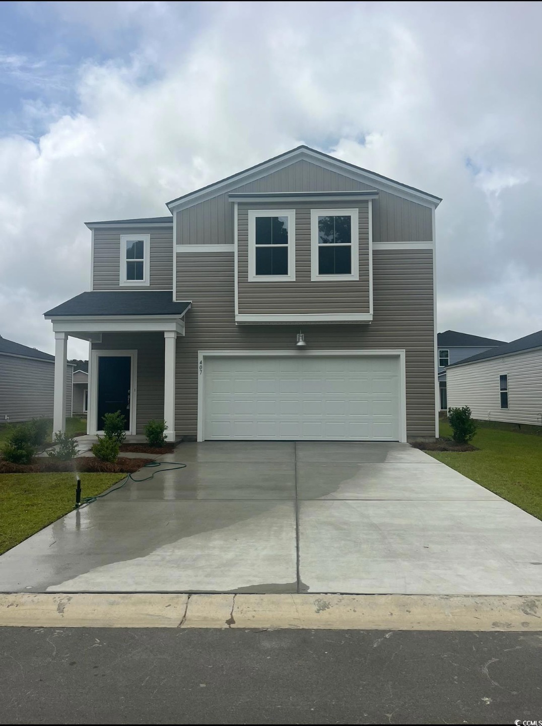 View of front facade with a garage and concrete driveway