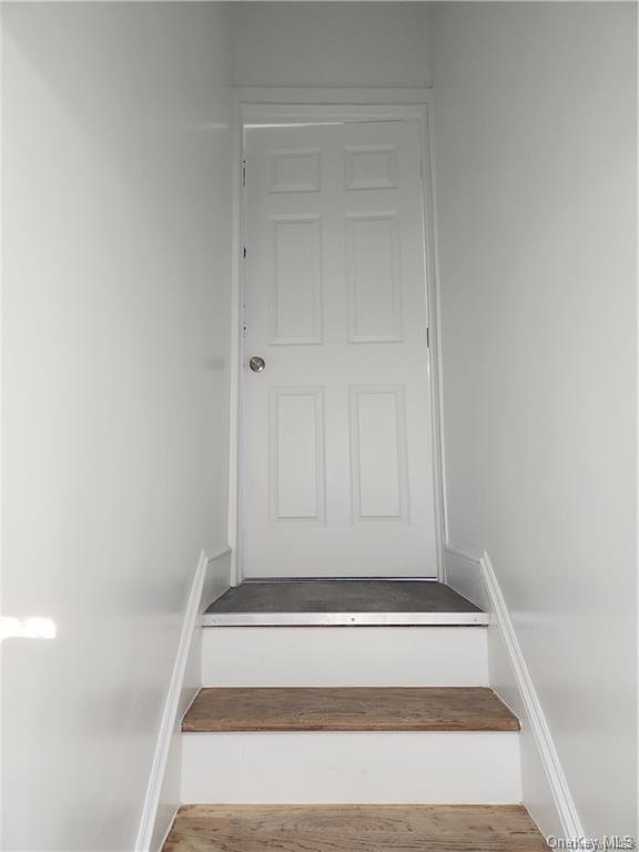 Stairway featuring hardwood / wood-style flooring