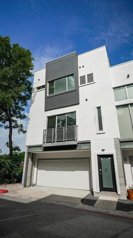 Front of townhouse facing west. Garage on bottom, 