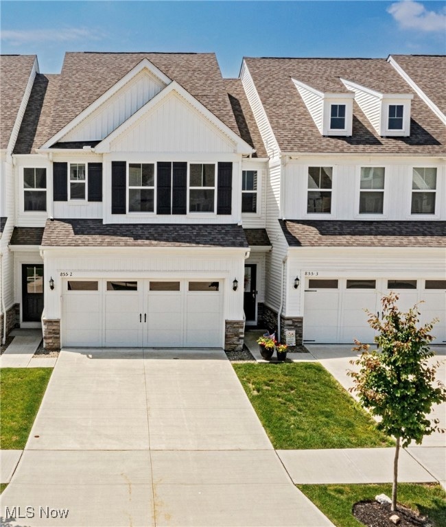 You’ve arrived home to a traditional façade with classic vinyl siding, elegant stacked stone, and timeless black shutters.