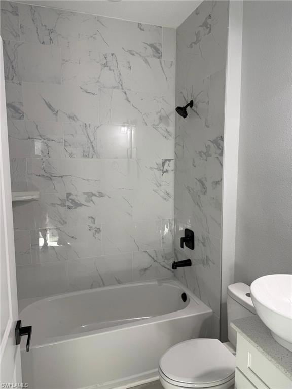 Bathroom featuring vanity, tub / shower combination, and toilet