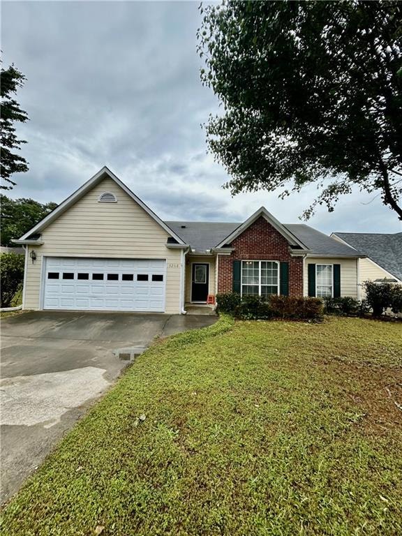 Single story home featuring concrete driveway, bri