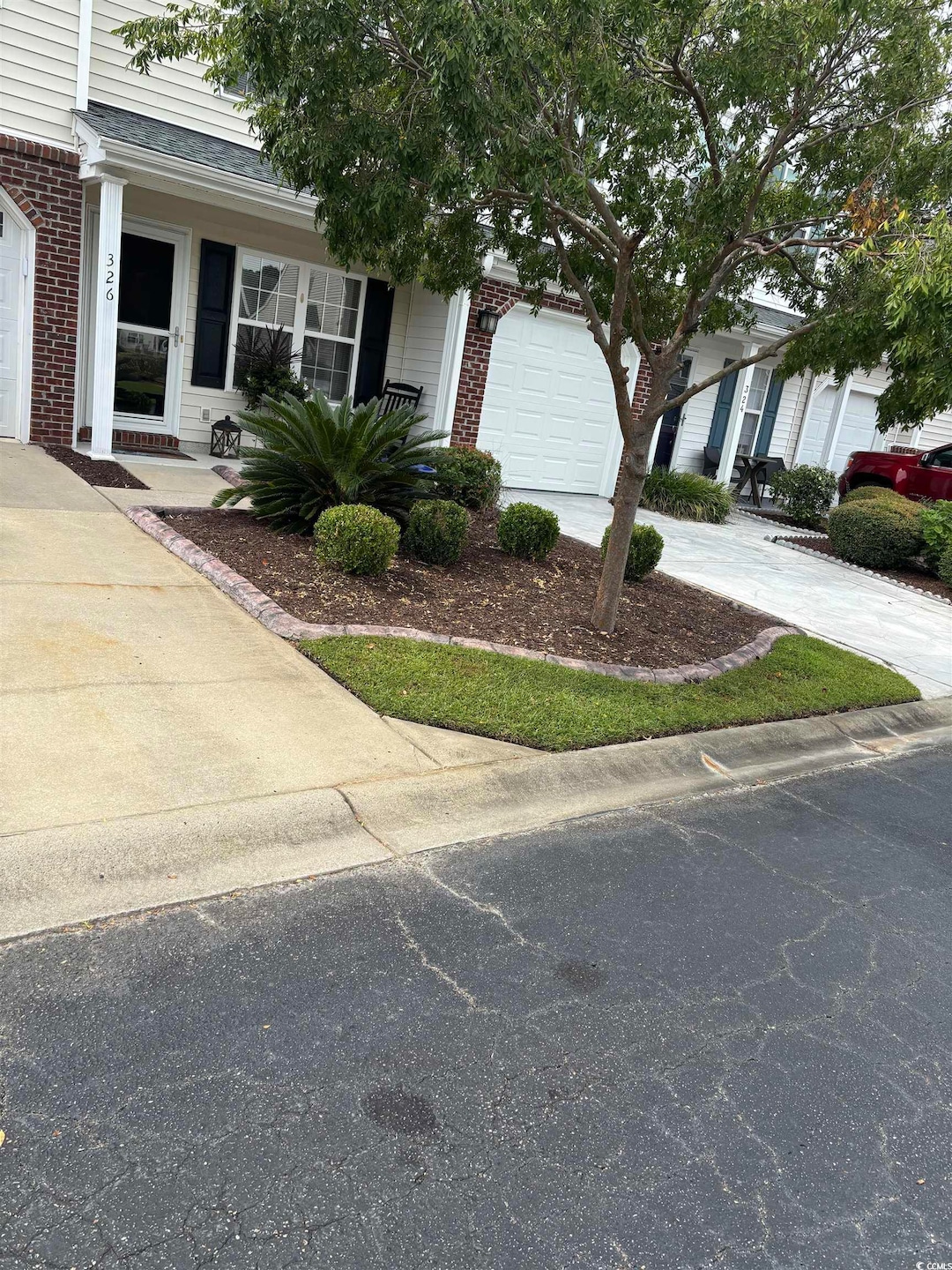 View of front of property featuring brick siding and driveway
