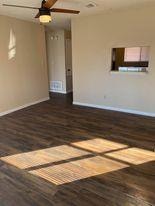 Unfurnished living room featuring wood finished f