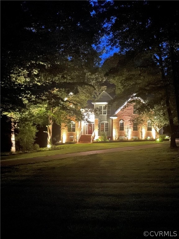 Beautifully Landscaped Yard with Exterior Uplighti