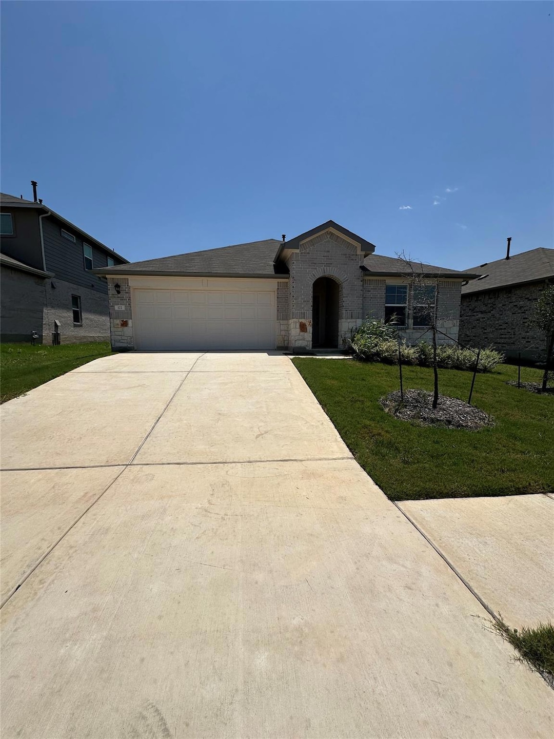 Single story home featuring a garage, concrete dr
