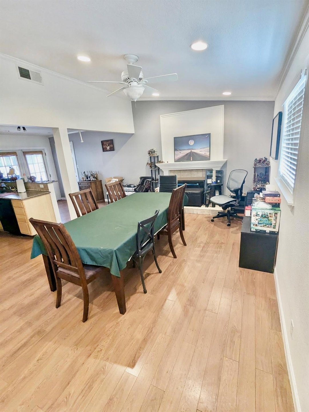 Dining space featuring visible vents, light wood-