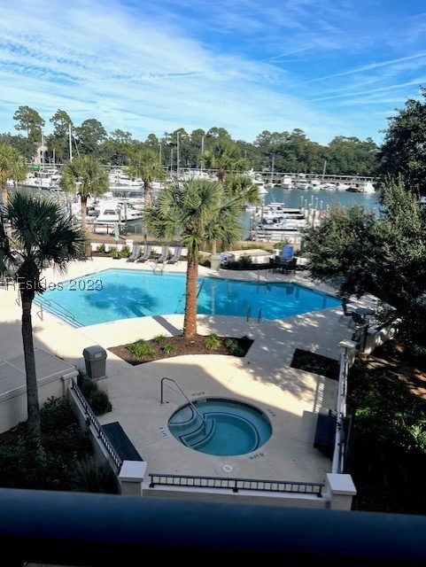 View of pool featuring a patio and a hot tub