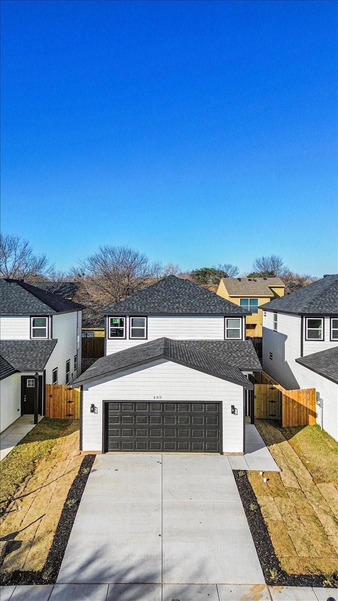 View of front of house with a garage and a front l