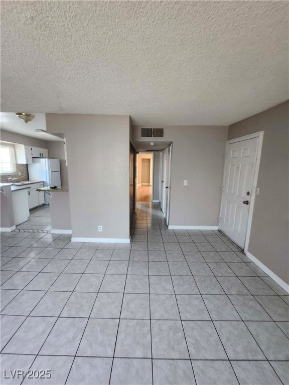 Unfurnished living room with light tile patterned