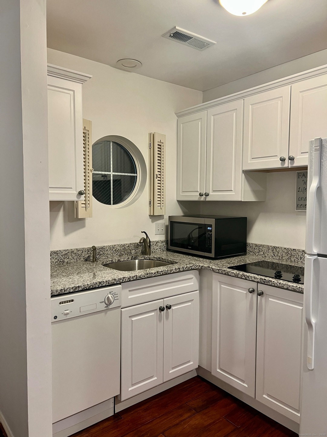 Remodeled kitchen - granite countertops and wide board flooring