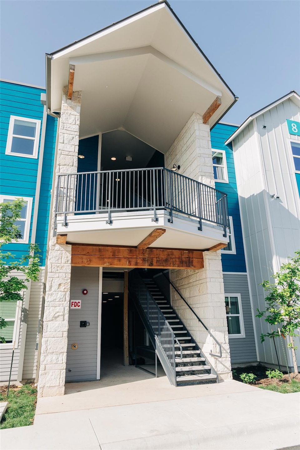 View of front of house featuring a balcony, drive