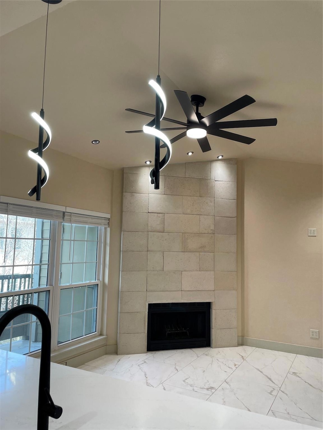 Details with a tiled fireplace, recessed lighting,